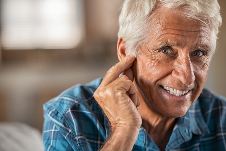 older man with hearing aid